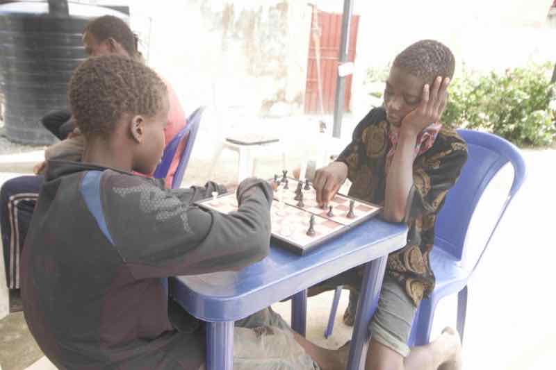 Students engaged in chess game for strategic thinking development