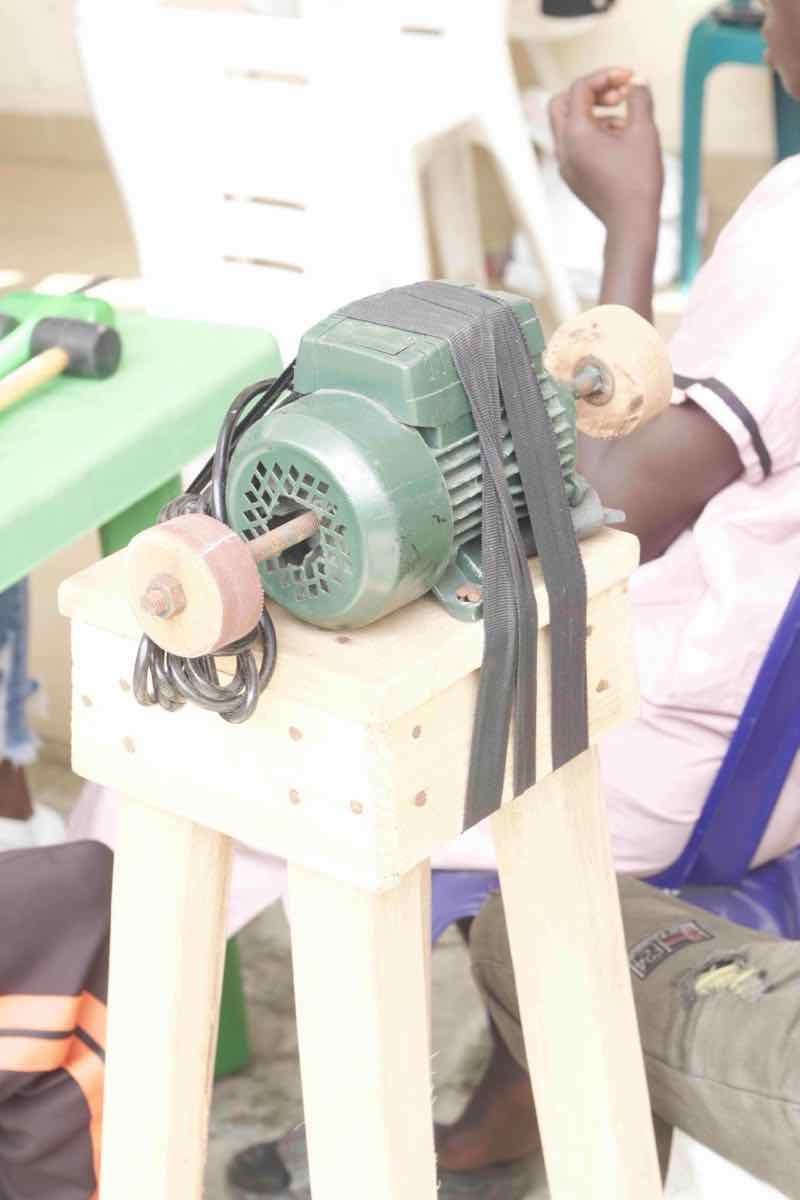Students practicing cobbling skills with guidance
