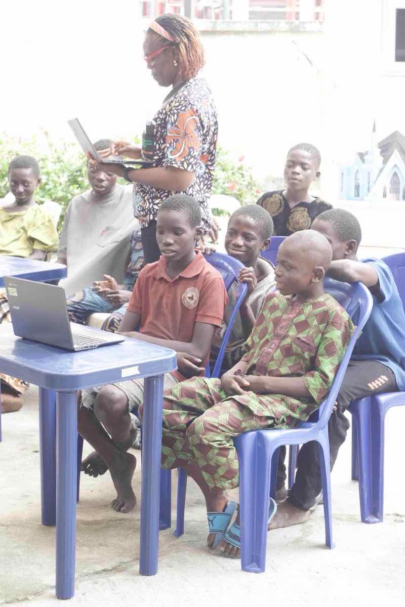 Young people learning digital skills using laptop computers