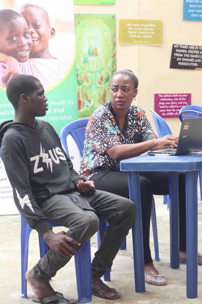 Volunteer mentor in deep conversation with young person