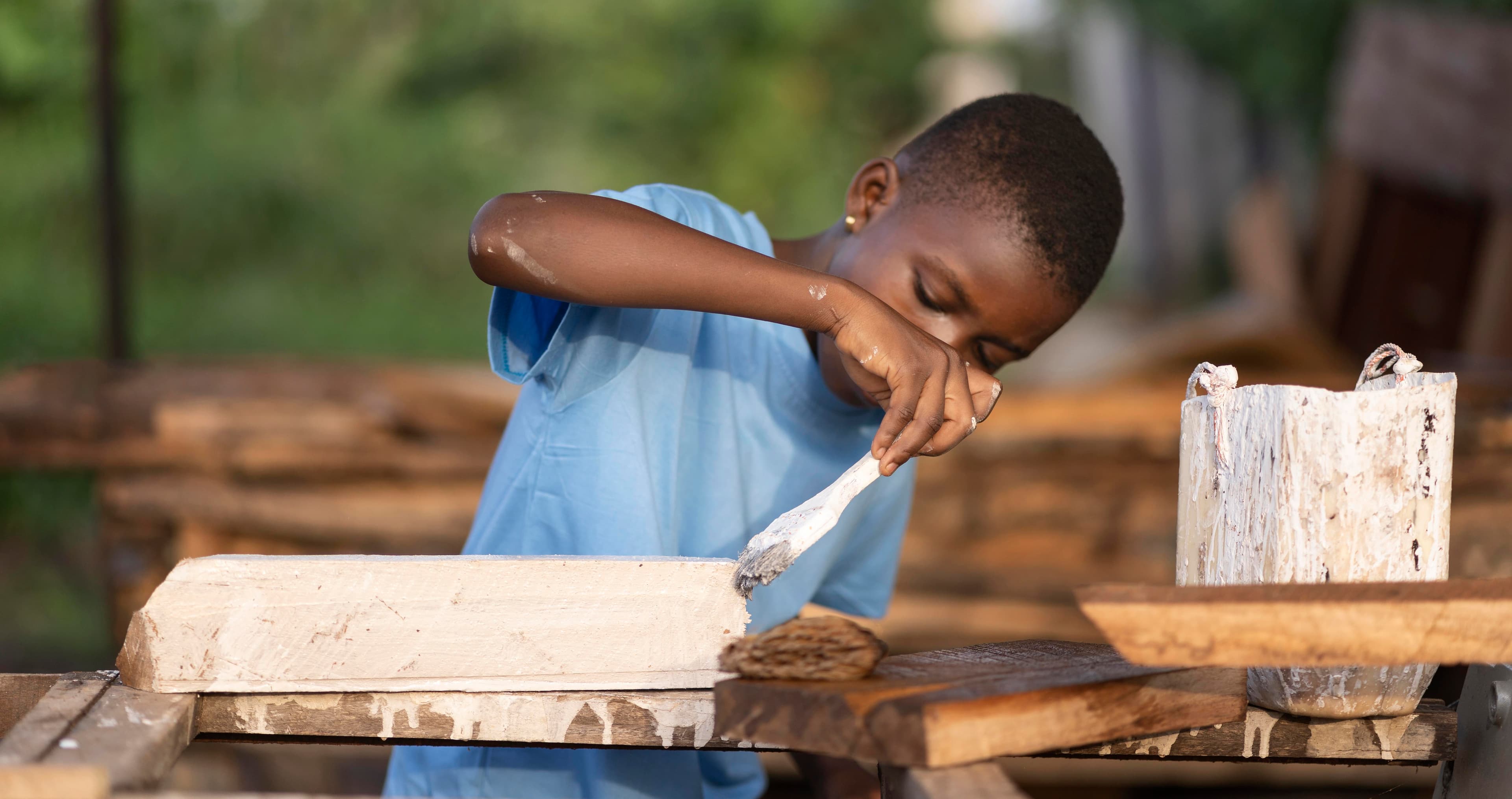boy painting wood